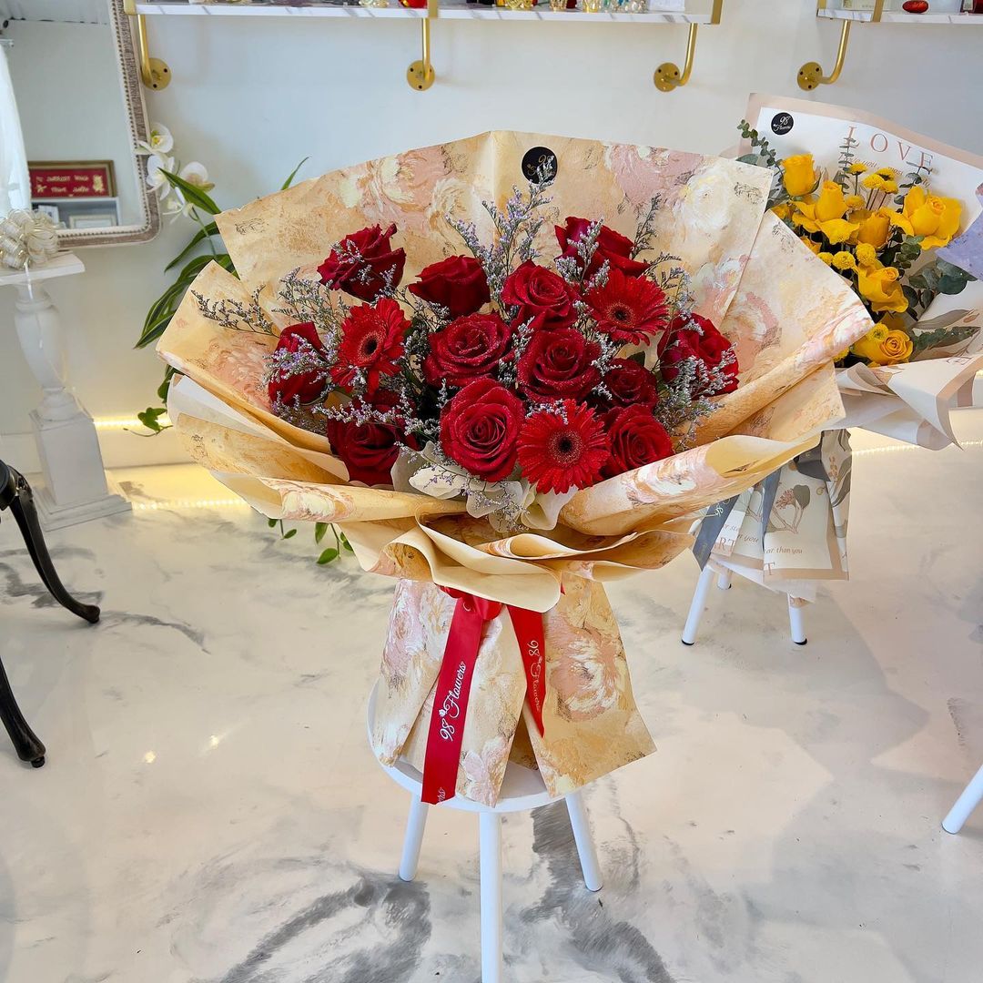 Red rose bouquet with golden fall wrapping