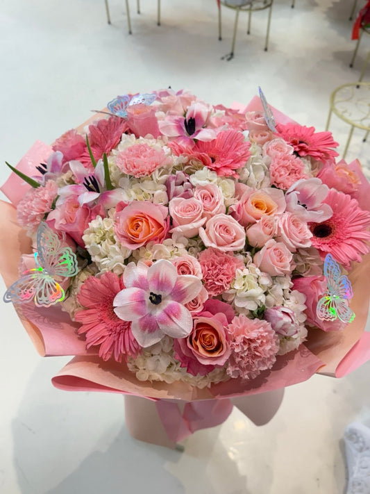 Oversized blush flower bouquet with butterfly accents