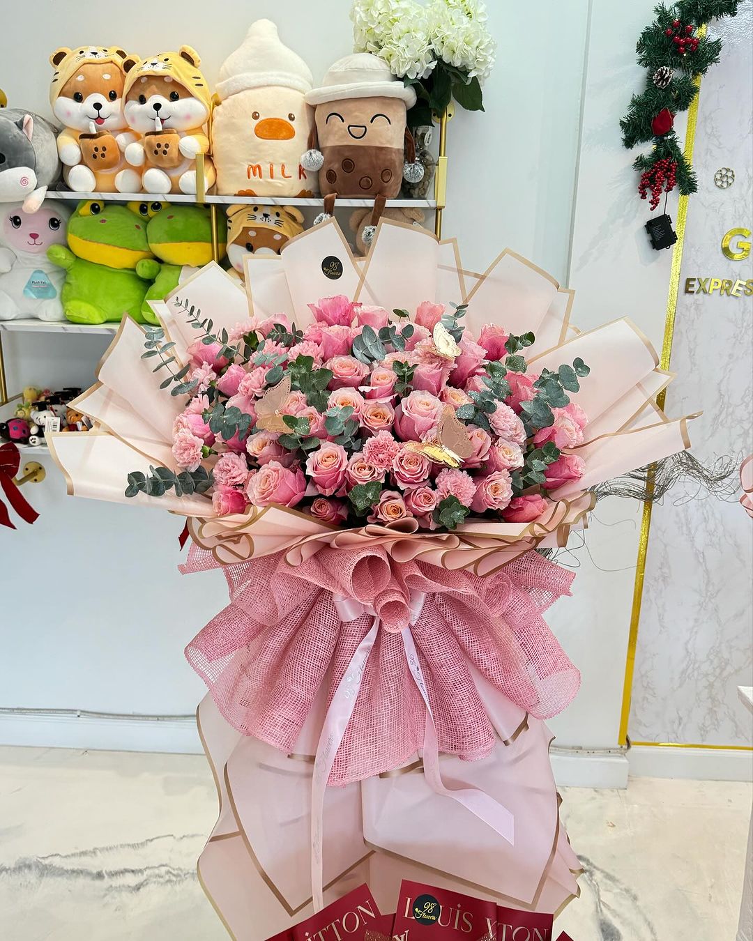 Giant pink rose bouquet with gold butterfly accents