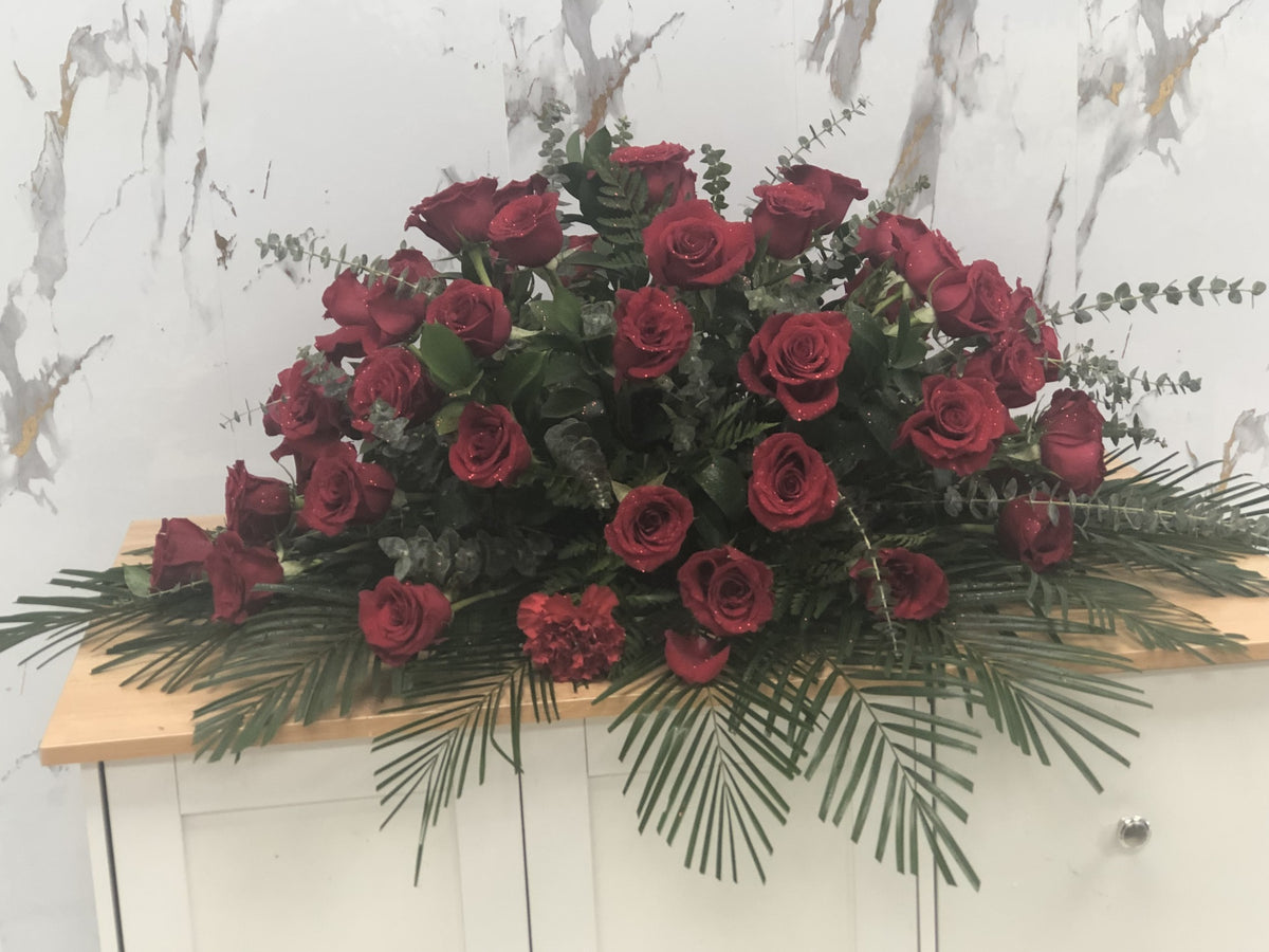 Red Rose Sympathy Casket Spray by LaDonna Flowers